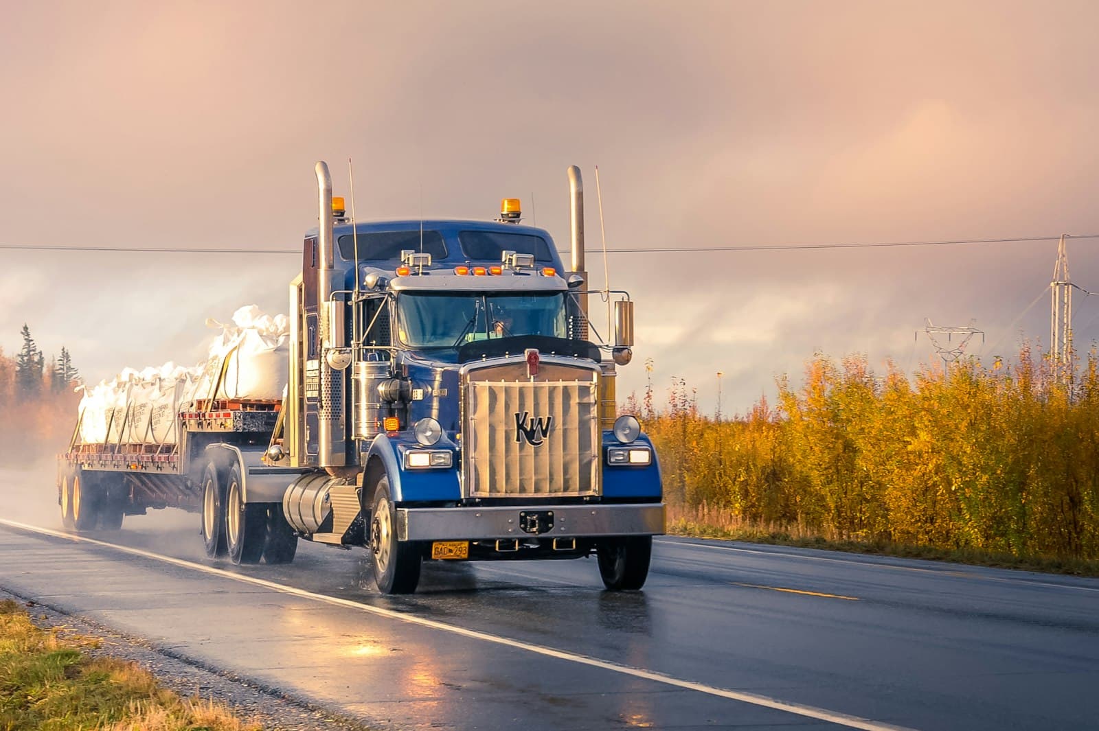 Heavy vehicle on a rain-soaked highway in poor visibility