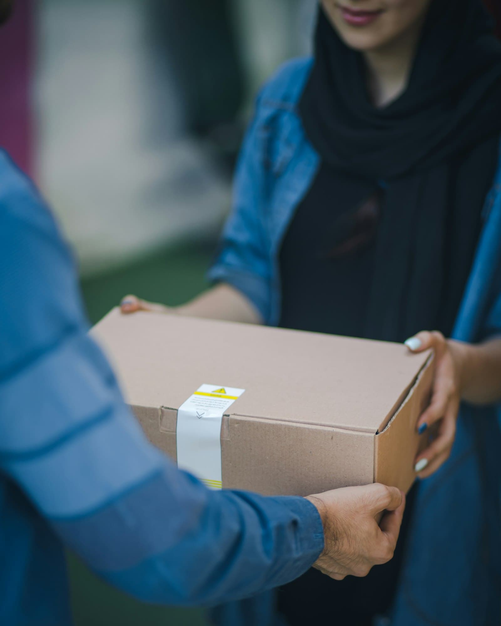 Courier handing a parcel to a customer